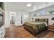 Comfortable bedroom with wood floors, a fireplace, built in shelving and natural light from large windows at 1208 E Crenshaw St, Tampa, FL 33604