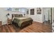 Comfortable bedroom with wood floors, built in shelving, and natural light from large windows at 1208 E Crenshaw St, Tampa, FL 33604