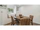 Cozy dining area featuring built-in shelving, a window seat, and a round wood table with seating for four at 1208 E Crenshaw St, Tampa, FL 33604