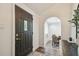 Elegant front entryway featuring a modern door, archway and view into the dining area at 1208 E Crenshaw St, Tampa, FL 33604