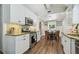 Spacious kitchen showcases white cabinets, stainless appliances, granite counters, and adjacent dining area at 1208 E Crenshaw St, Tampa, FL 33604