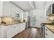 Kitchen featuring granite counters, stainless appliances, herringbone backsplash, and a view to outdoor patio at 1208 E Crenshaw St, Tampa, FL 33604