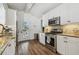 Bright kitchen with stainless appliances, including gas range, granite countertops, and access to the outdoors at 1208 E Crenshaw St, Tampa, FL 33604