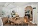 Bright eat-in kitchen with white cabinets, stainless appliances, and wood-look floors, adjacent to entry and living spaces at 1208 E Crenshaw St, Tampa, FL 33604