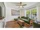 Bright living room featuring a modern ceiling fan, large windows, and comfortable seating at 1208 E Crenshaw St, Tampa, FL 33604