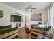 Bright living room featuring a modern ceiling fan, built-in shelves, and comfortable seating at 1208 E Crenshaw St, Tampa, FL 33604