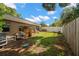 Spacious backyard with lawn, wooden fence, and gardening area at 1309 Eastfield Dr, Clearwater, FL 33764