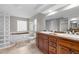 Bright primary bathroom with dual sinks, a glass block shower, and a soaking tub at 1309 Eastfield Dr, Clearwater, FL 33764