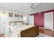 Bright bedroom with a ceiling fan, wood floors, and stylish modern accents at 1309 Eastfield Dr, Clearwater, FL 33764