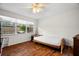 Cozy bedroom with hardwood floors, lots of natural light, and bright neutral walls at 1309 Eastfield Dr, Clearwater, FL 33764