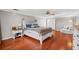 A spacious bedroom features hardwood floors, a ceiling fan and a cozy sitting area at 1309 Eastfield Dr, Clearwater, FL 33764