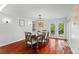 Bright dining room boasts wood floors, wainscoting, and French doors to the outdoor patio at 1309 Eastfield Dr, Clearwater, FL 33764