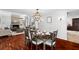 An open-concept dining area with hardwood floors, a chandelier, and a view of the fireplace at 1309 Eastfield Dr, Clearwater, FL 33764