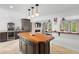 Kitchen featuring stainless steel appliances, custom cabinets, wet bar, and large kitchen island at 1309 Eastfield Dr, Clearwater, FL 33764
