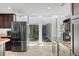 Bright kitchen features stainless appliances, an island, and sliding glass doors that open to the patio at 1309 Eastfield Dr, Clearwater, FL 33764