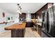 Kitchen features a wood top island, stainless steel appliances, dark wood cabinetry, and tile backsplash at 1309 Eastfield Dr, Clearwater, FL 33764