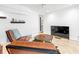 Cozy living room with a large flat screen tv, leather chairs, and access to the backyard at 1309 Eastfield Dr, Clearwater, FL 33764