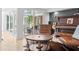 Stylish living room with a piano, exposed guitars, leather chairs, and exposed doors to the outdoor patio at 1309 Eastfield Dr, Clearwater, FL 33764