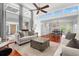 Spacious living room with hardwood floors, bright sofas, modern ceiling fan, and lots of natural light at 1309 Eastfield Dr, Clearwater, FL 33764