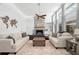 Lovely and bright living room with a stone fireplace, hardwood floors, light walls, and large windows at 1309 Eastfield Dr, Clearwater, FL 33764