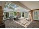 The beautiful enclosed and screened in patio has lovely tile flooring and an outdoor dining set at 1309 Eastfield Dr, Clearwater, FL 33764