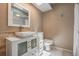 Modern bathroom featuring a vessel sink, white vanity, decorative mirror, and tiled walls at 13167 Roseanna Dr, Spring Hill, FL 34609