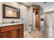 Bathroom featuring dual vanities, tiled floors, a walk-in shower with glass door, and neutral tones at 13167 Roseanna Dr, Spring Hill, FL 34609