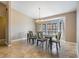 Inviting dining room featuring tile flooring, a chandelier, and a large bay window for natural light at 13167 Roseanna Dr, Spring Hill, FL 34609
