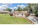 A well-manicured lawn with manicured landscaping surrounds the home in a neighborhood at 13167 Roseanna Dr, Spring Hill, FL 34609