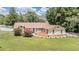 A well-maintained home with a manicured lawn and mature landscaping at 13167 Roseanna Dr, Spring Hill, FL 34609