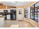 Kitchen featuring white cabinets, granite countertops, black appliances, and a view to the backyard at 13167 Roseanna Dr, Spring Hill, FL 34609