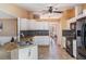 Kitchen boasts white cabinetry, granite countertops, tile backsplash, and stainless steel appliances at 13167 Roseanna Dr, Spring Hill, FL 34609