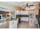 Updated kitchen boasts granite countertops, white cabinetry, black appliances, and open access to the living room at 13167 Roseanna Dr, Spring Hill, FL 34609