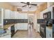 Kitchen boasts white cabinetry, granite countertops, tile backsplash, and stainless steel appliances at 13167 Roseanna Dr, Spring Hill, FL 34609