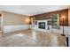 Spacious living room featuring a white brick fireplace, wood accent wall, and tile floors at 13167 Roseanna Dr, Spring Hill, FL 34609