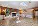 Bright living room with a modern fireplace, neutral paint, and large windows offering ample natural light at 13167 Roseanna Dr, Spring Hill, FL 34609