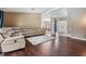 Bright living room featuring hardwood floors, neutral walls, a plush sectional sofa and an open floor plan at 13167 Roseanna Dr, Spring Hill, FL 34609