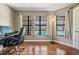 Bright office space with wood floors, large windows overlooking the pool, and modern furnishings at 13167 Roseanna Dr, Spring Hill, FL 34609