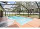 Screened-in pool area featuring a refreshing pool with a spacious deck and an outdoor area at 13167 Roseanna Dr, Spring Hill, FL 34609