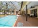 An expansive screened-in pool area with ample seating provides a perfect space for outdoor relaxation at 13167 Roseanna Dr, Spring Hill, FL 34609
