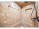 Close up of a tiled shower with a rainfall showerhead, built-in niche, and neutral color palette at 13167 Roseanna Dr, Spring Hill, FL 34609