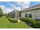 Backyard area showcasing a screened-in porch and well-maintained landscaping at 13524 Circa Crossing Dr, Lithia, FL 33547