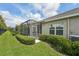 Backyard featuring screened lanai, with lush landscaping and well-maintained lawn, offering a serene outdoor space at 13524 Circa Crossing Dr, Lithia, FL 33547