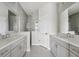 A modern bathroom featuring double sinks and a glass enclosed shower at 13524 Circa Crossing Dr, Lithia, FL 33547