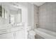 Modern bathroom with double sink vanity, tiled shower-tub combo, and neutral color scheme at 13524 Circa Crossing Dr, Lithia, FL 33547