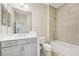 Bathroom featuring a large mirror, single sink vanity, and tub with tiled surround at 13524 Circa Crossing Dr, Lithia, FL 33547