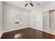 Bedroom featuring hardwood floors, ceiling fan, and natural light at 13524 Circa Crossing Dr, Lithia, FL 33547
