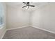 View of the bedroom with neutral walls, gray carpet, ceiling fan and one window at 13524 Circa Crossing Dr, Lithia, FL 33547