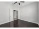 Bright bedroom with dark hardwood floors, and a double door entrance to an attached bathroom at 13524 Circa Crossing Dr, Lithia, FL 33547
