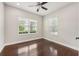 Cozy bedroom with hardwood floors and natural light from two windows at 13524 Circa Crossing Dr, Lithia, FL 33547
